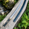 Yin Yang Katana with polished steel blade, black wrapped handle, gold-tone Yin Yang guard, and matching black scabbard.