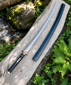 Yin Yang Katana with polished steel blade, black wrapped handle, gold-tone Yin Yang guard, and matching black scabbard.