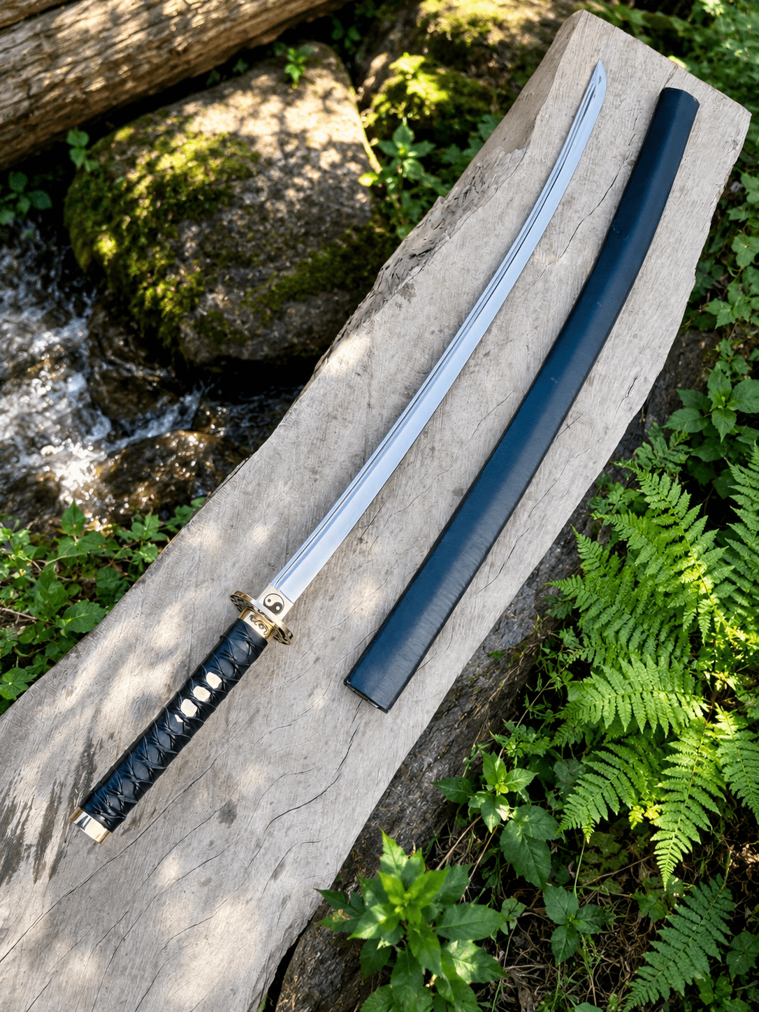 Yin Yang Katana with polished steel blade, black wrapped handle, gold-tone Yin Yang guard, and matching black scabbard.