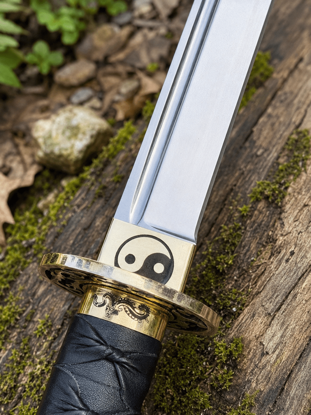 Yin Yang Katana with polished steel blade, black wrapped handle, gold-tone Yin Yang guard, and matching black scabbard.