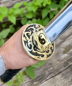 Yin Yang Katana with polished steel blade, black wrapped handle, gold-tone Yin Yang guard, and matching black scabbard.
