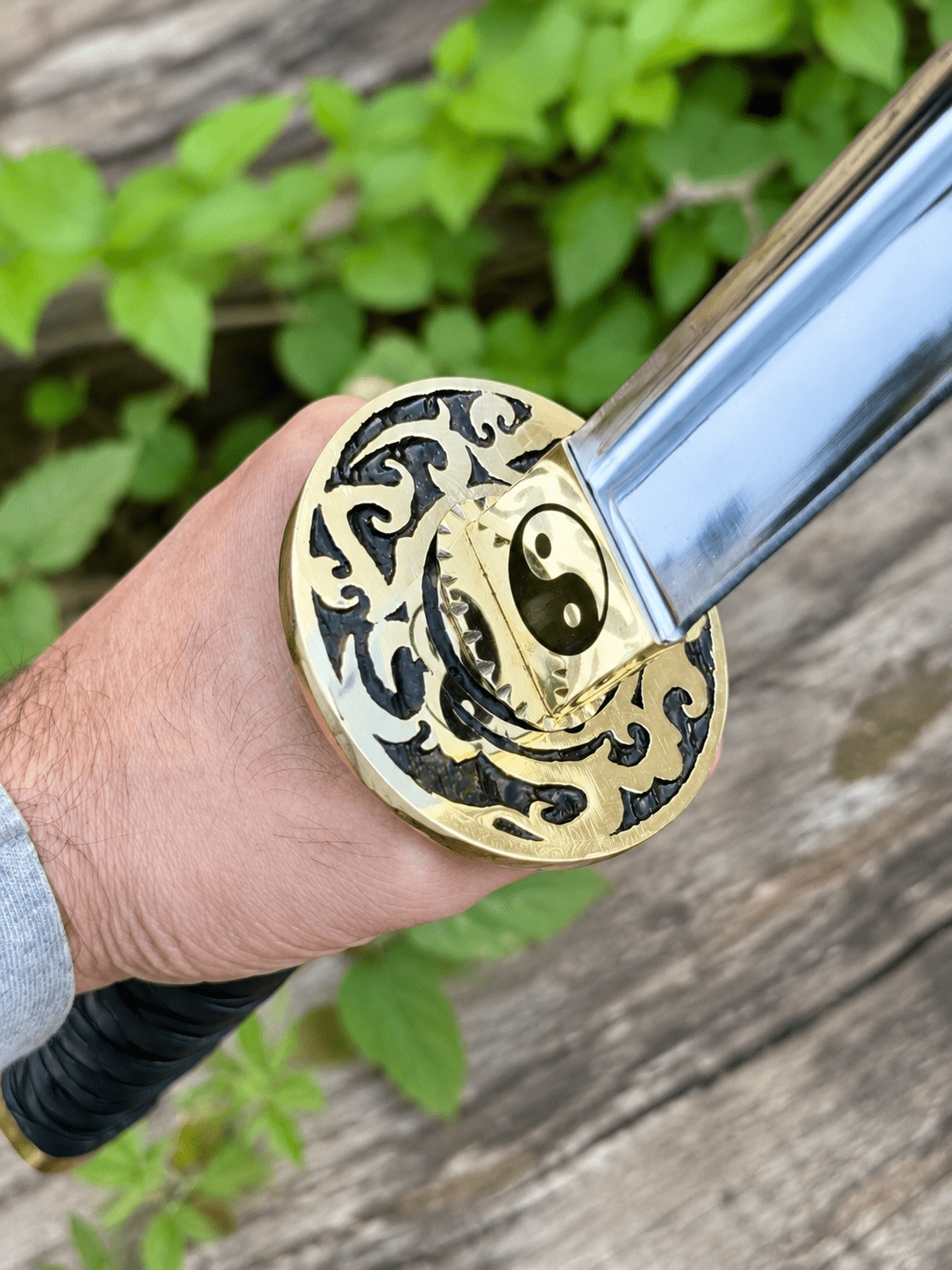 Yin Yang Katana with polished steel blade, black wrapped handle, gold-tone Yin Yang guard, and matching black scabbard.