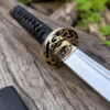 Yin Yang Katana with polished steel blade, black wrapped handle, gold-tone Yin Yang guard, and matching black scabbard.
