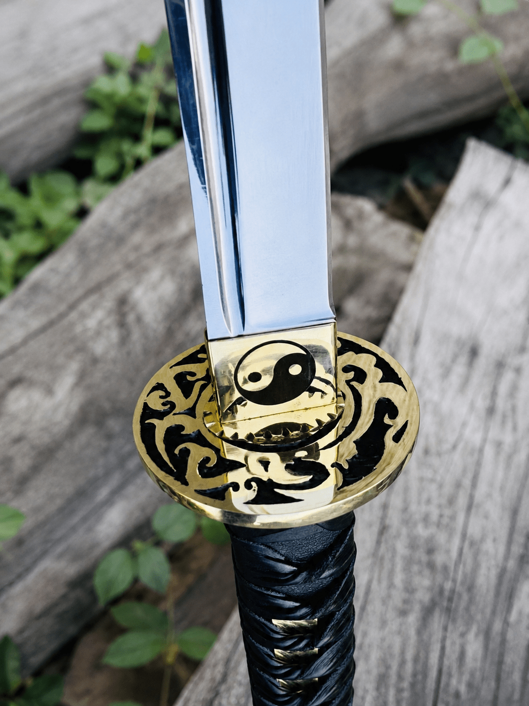 Yin Yang Katana with polished steel blade, black wrapped handle, gold-tone Yin Yang guard, and matching black scabbard.