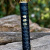 Yin Yang Katana with polished steel blade, black wrapped handle, gold-tone Yin Yang guard, and matching black scabbard.