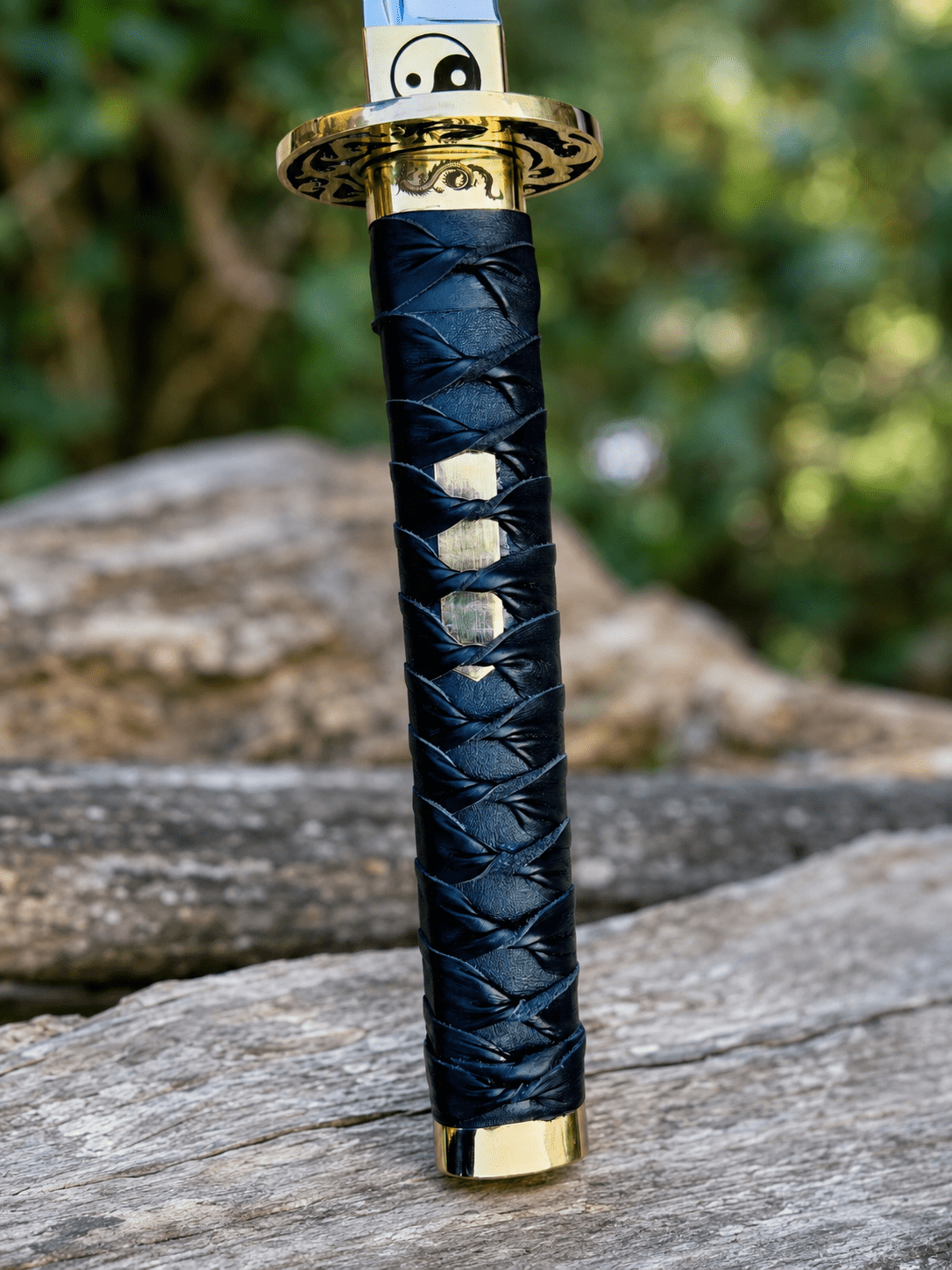 Yin Yang Katana with polished steel blade, black wrapped handle, gold-tone Yin Yang guard, and matching black scabbard.